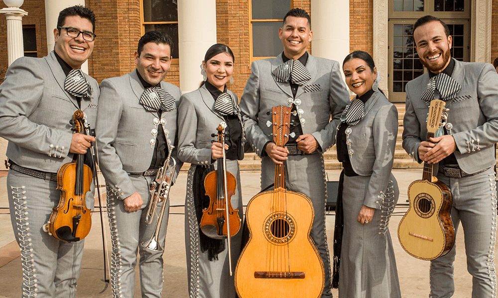 Image of Mariachi Voces Tapatias Band, with instruments in front of City Hall